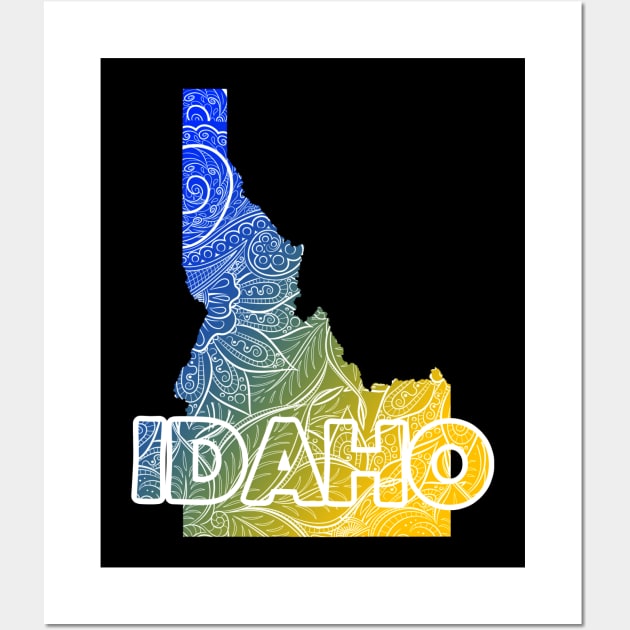 Colorful mandala art map of Idaho with text in blue and yellow Wall Art by Happy Citizen